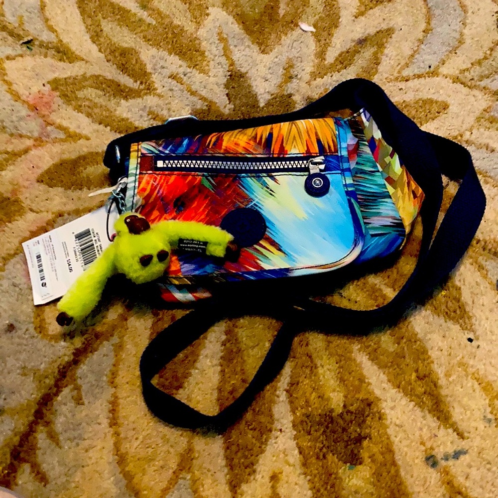A Kipling bag, with a neon monkey